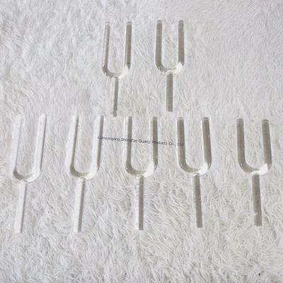 Crystal tuning fork transparent quartz gentle tapping on the ear for precise tuning and stress relief