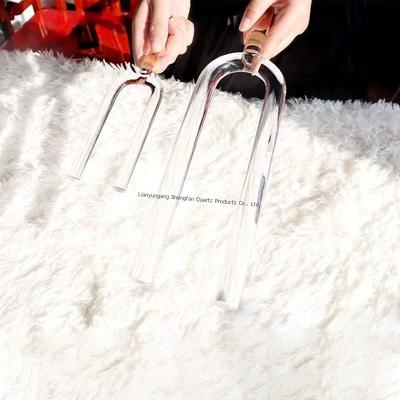 Crystal tuning fork transparent quartz gentle tapping on the ear for precise tuning and stress relief
